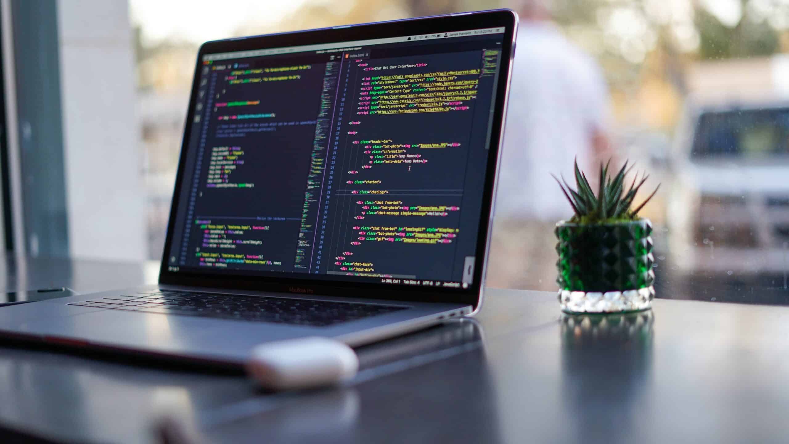 technology company - laptop showing coding sequence program
