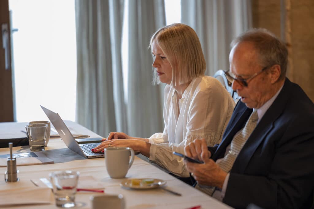 Woman using a laptop in a meeting 