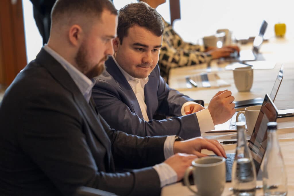 Two business men at a conference table 
