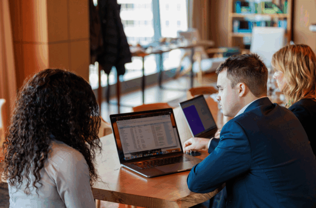 Business brokers at Exit Equity reviewing metrics on a laptop